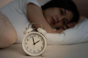 woman in bed late trying to sleep suffer insomnia, sleepless or scared in a nightmare, looking sad worried and stressed. Tired and headache or migraine waking up in the middle of the night photo