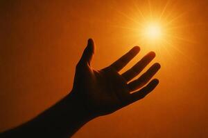 image of a hand reaching towards glowing light symbolizing strength hope and courage under adversity photo