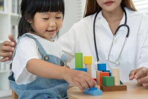 Pediatricians are checking the children development according to the appropriate age, doctors encourage the child to do activities, IQ, EQ, age appropriate learning activities and promotion. photo