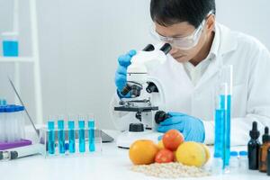 Scientist check chemical food residues in laboratory. Control experts inspect quality of fruits, vegetables. lab, hazards, ROHs, find prohibited substances, contaminate, Microscope Microbiologist. photo