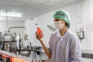 supervisor food or beverages technician inspection about condition control food or beverages before send product to the customer. Production leader recheck machine and productivity. photo