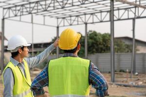inspector engineer and owner project inspecting construction and quality assurance new house. Engineers or architects or contactor work to build the house. photo