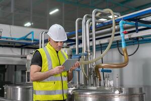 Portrait Engineer or utility staff wearing safety helmet fix the machines in the production line. Utility inspector check machine and test the system to meet the standard Preventive Maintenance photo