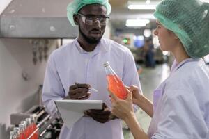 beverages technician inspection about quality control food or beverages before send product to the customer. Production leader recheck ingredient and productivity photo