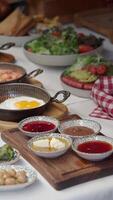 A vibrant brunch table adorned with salads, sauces, and crispy delights video
