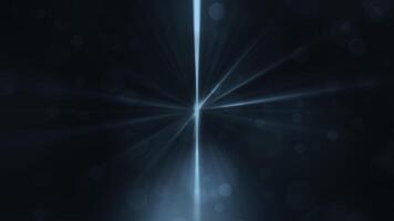 Loop blue bokeh particles with shine rays on black background video