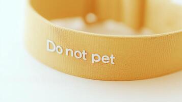 Yellow dog collar with Do not pet warning text for anxious dogs. Safety awareness collar communicating boundaries to strangers about reactive or nervous pets. photo