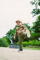 A Cheerful Child Joyfully Playing Outdoors in the Embrace of Nature Taking Happy Steps on an Adventure Filled with Excitement and Discovery, Exploring the World Around Him with Glee photo