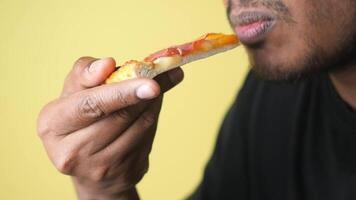 Enjoying a tasty pizza slice with flavorful toppings video