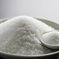 A bowl of sugar with a spoon photo