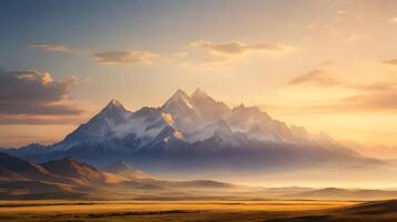 Majestic snow-capped mountains at sunset, golden light over vast plains and hazy valleys photo