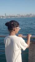 Girl enjoying a view of the city from the waterfront video