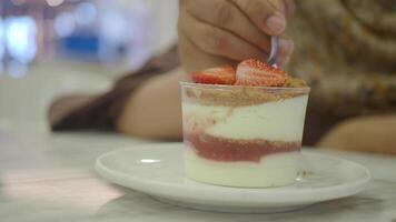 Enjoying a delicious dessert with strawberries and cream video