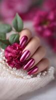 Close-up of a metallic manicure in the color of fuchsia on long oval nails. photo