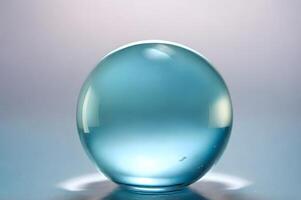 Translucent Teal Glass Orb on Subtle Gradient Background photo
