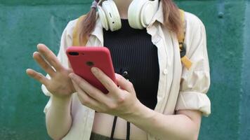 Young woman communicating using mobile phone. Female hands browsing internet, using social media on smartphone on street. video