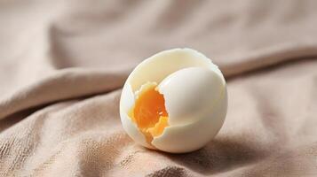 Soft Boiled Egg with Broken Shell on Textured Beige Fabric Background photo