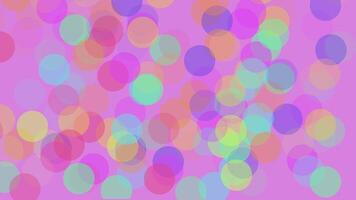 Abstract pink background from the emergence of multi-colored round particles video
