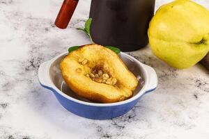 A bowl of fruit and a coffee pot on a table photo
