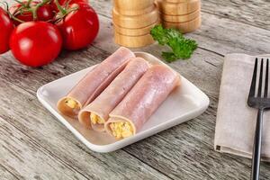 Ham and egg rolls on a plate with a fork and knife photo