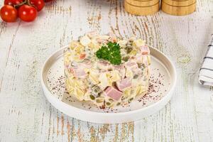 A plate with a salad on it and some vegetables photo