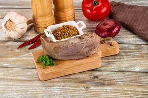 A meat and spices on a cutting board photo
