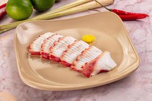 A plate with sliced meat on it and some peppers photo