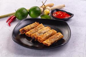 A plate with some rolls and some vegetables photo