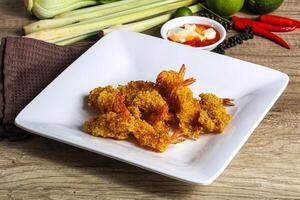 A plate of fried shrimp and vegetables on a table photo