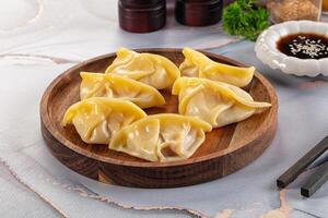 A plate with dumplings on it and some chopsticks photo