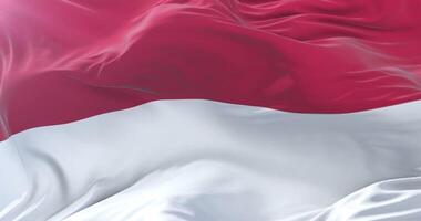 Flag of Indonesia waving at wind in slow in blue sky loop video