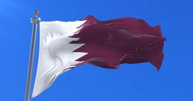 Qatar flag waving at wind in slow with blue sky, loop video