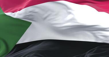 Sudan flag waving at wind in slow in blue sky, loop video