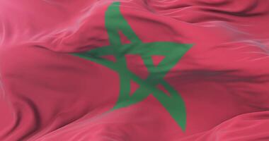 Morocco flag waving at wind in slow in blue sky, loop video