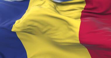 Flag of Romania waving at wind in slow with blue sky, loop video