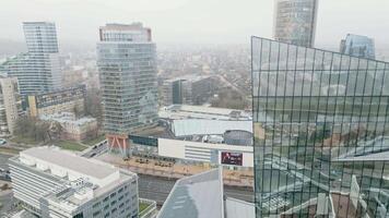 Vilnius, Lithuania - 27th november, 2024- aerial view capital city Vilnius central business district in Snipiskes area.Europa Shopping Center. Business skyline architecture and cars in traffic video