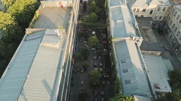 Tbilisi, Georgia - 1st july, 2025- Aerial Fabrika courtyard in Tbilisi, vibrant social hub with outdoor seating, trees, string lights, groups of guests enjoying the lively atmosphere in heart of city. video
