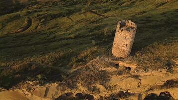 Aerial top down view of an ancient stone watchtower standing alone on a remote ridge in David Gareja, Georgia, symbolizing medieval defense, isolation, and border vigilance. video