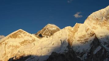 Mount Everest peak. Earth's highest mountain above sea level. Mahalangur Himalaya sub-range of the Himalayaayas in Nepalese side. Sunset last sunny spells before night.Clear blue sky video