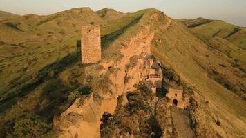 Aerial close up view of an ancient stone watchtower standing alone on a remote ridge in David Gareja, Georgia, symbolizing medieval defense, isolation, and border vigilance. video