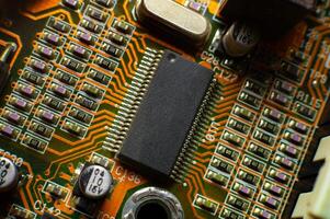 Elements of microcircuits on a green and red board. Microprocessor on the board. Old processor photo