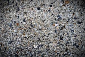 Background, Cement wall surface, damaged, revealed that many granite stones are components. photo