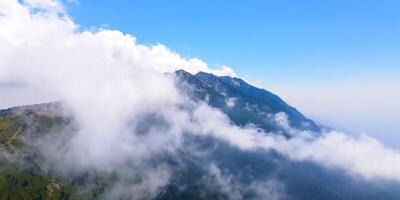 A view of the mountains from above with clouds photo
