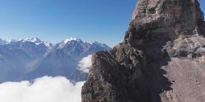 A mountain with a large rock on top photo