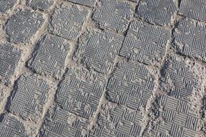 A closeup view of textured paving stones placed on a walkway or pathway surface photo