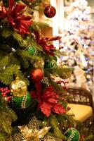Christmas tree decorated with red and green baubles and ornaments photo