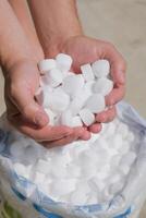 man hands holding salt for cleaning pool photo