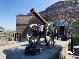 A cannon in front of a building, castle cannon photo