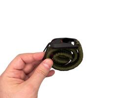 Green camera strap in the form of a rope on a white background. copy space, top photo