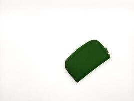 Small green fabric wallet on white background. copy space, flay lay photo